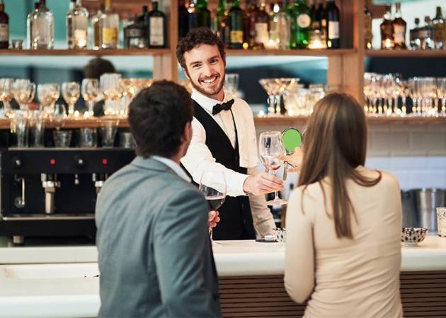 barman serves a couple alcohol drinks on a date with hospitality
