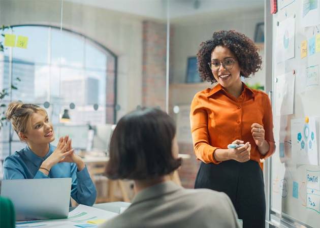 woman business owner talking about growth to staff