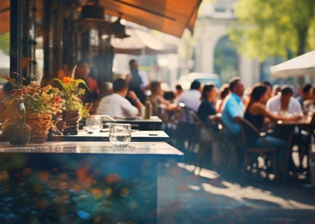 An outdoor restaurant patio bustles with diners enjoying meals