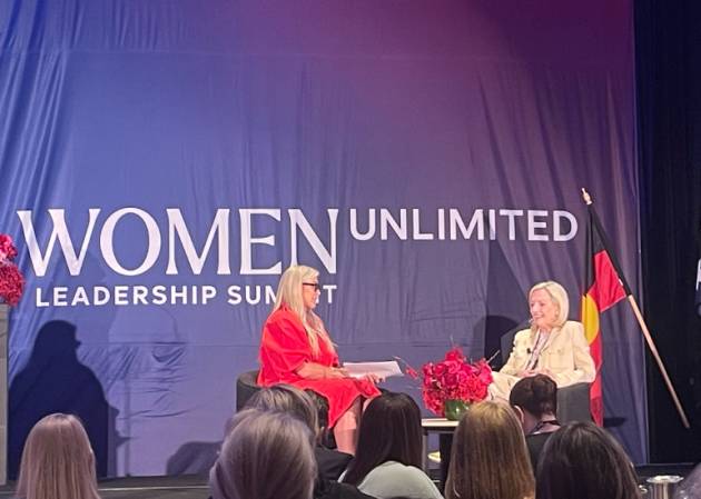 Christine Holgaet speaking at the Women Unlimited conference