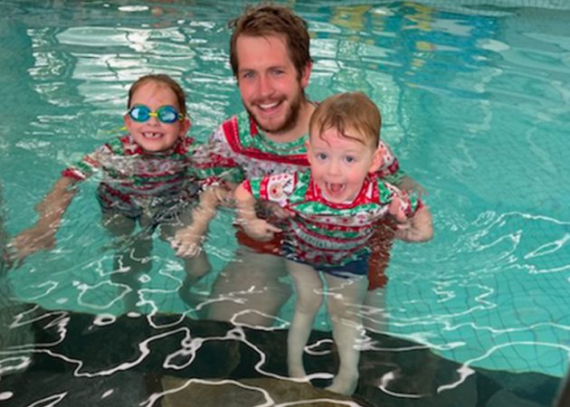 dad and kids in matching xmas swim rashies in a pool